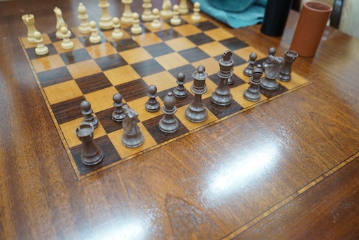 A reproduction square mahogany inlaid games table with chequer board surface, interior with baize and backgammon surfaces, width 91cm, height 78cm